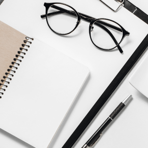 notepad with glasses